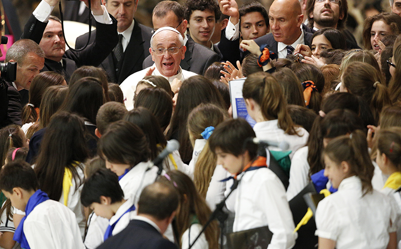 Pope Francis is surrounded by children during a special audience with students of Jesuit schools in Paul VI hall at the Vatican on June 7, 2013. Photo courtesy of REUTERS/Max Rossi *Editors: This photo may only be republished with RNS-POPE-JESUIT, originally transmitted on September 15, 2015.